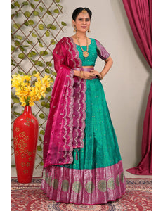 Woman wearing a green and pink traditional outfit with a matching dupatta