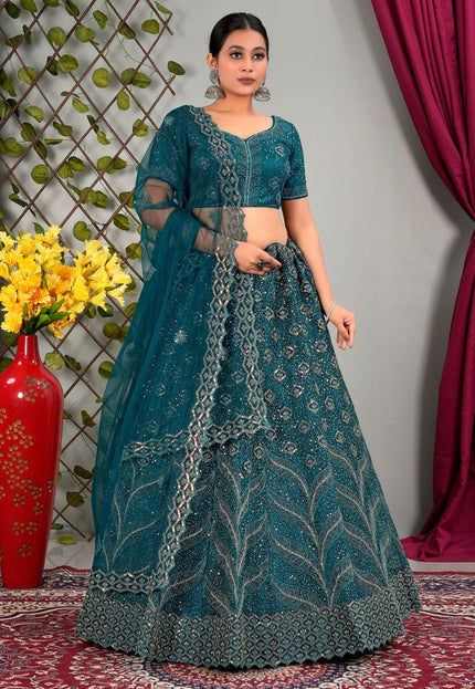 Woman wearing a teal traditional outfit with matching dupatta