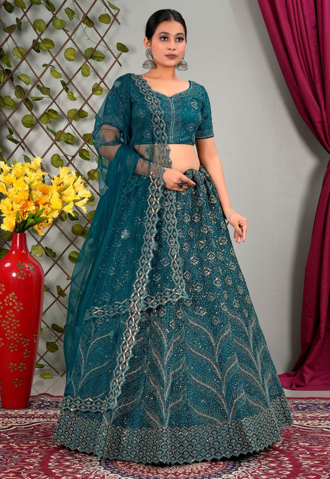 Woman wearing a teal traditional outfit with matching dupatta