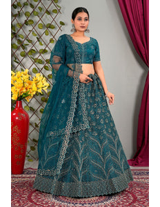 Woman wearing a teal traditional outfit with matching dupatta