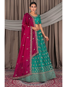 Woman wearing a traditional green and pink saree with a matching blouse