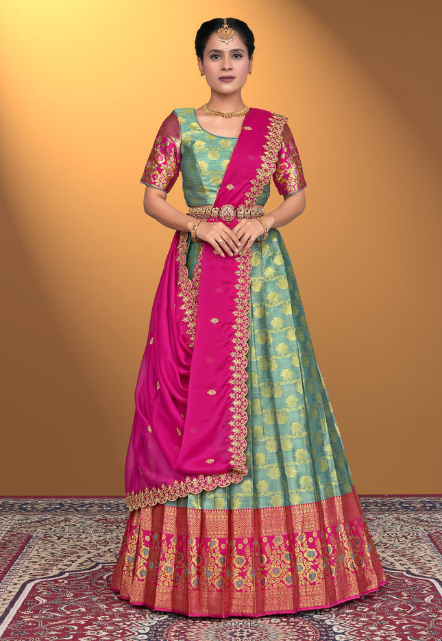 Woman wearing a traditional green and pink lehenga choli