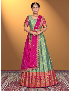 Woman wearing a traditional green and pink lehenga choli