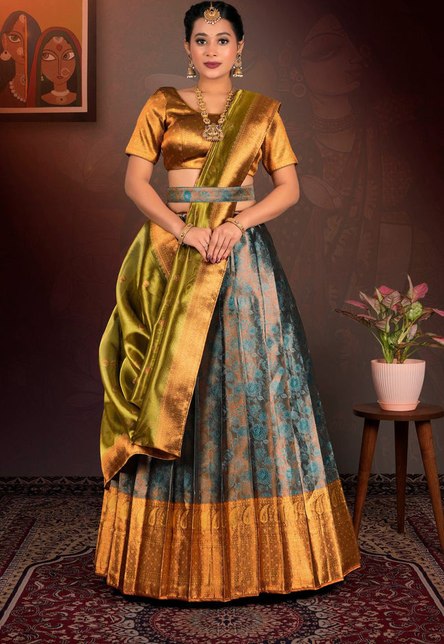 Woman in a traditional gold and blue lehenga choli with dupatta