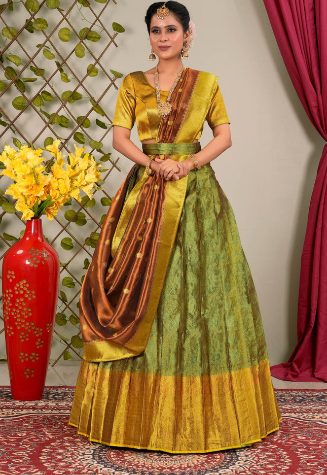 Woman in a green and gold traditional lehenga choli with dupatta