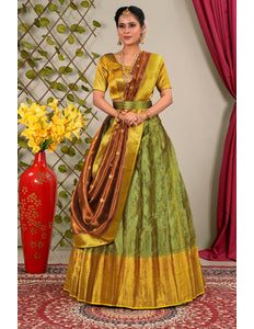 Woman in a green and gold traditional lehenga choli with dupatta
