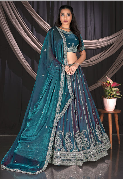 Woman wearing a teal embroidered traditional lehenga choli