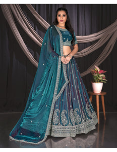 Woman wearing a teal embroidered traditional lehenga choli