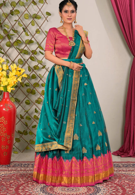 Woman wearing a teal saree with pink blouse with dupatta