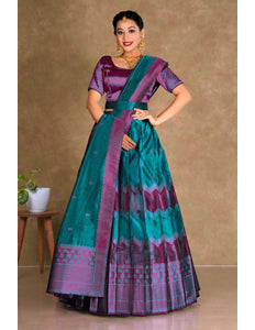 Woman wearing a traditional teal and purple lehenga with a matching blouse