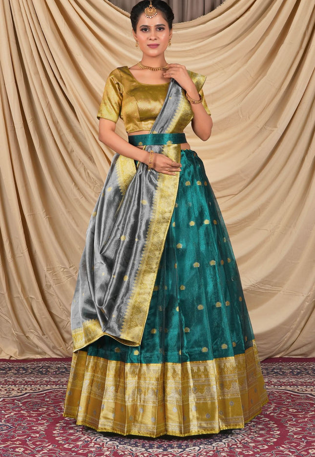 Woman wearing a traditional green and gold lehenga choli with dupatta