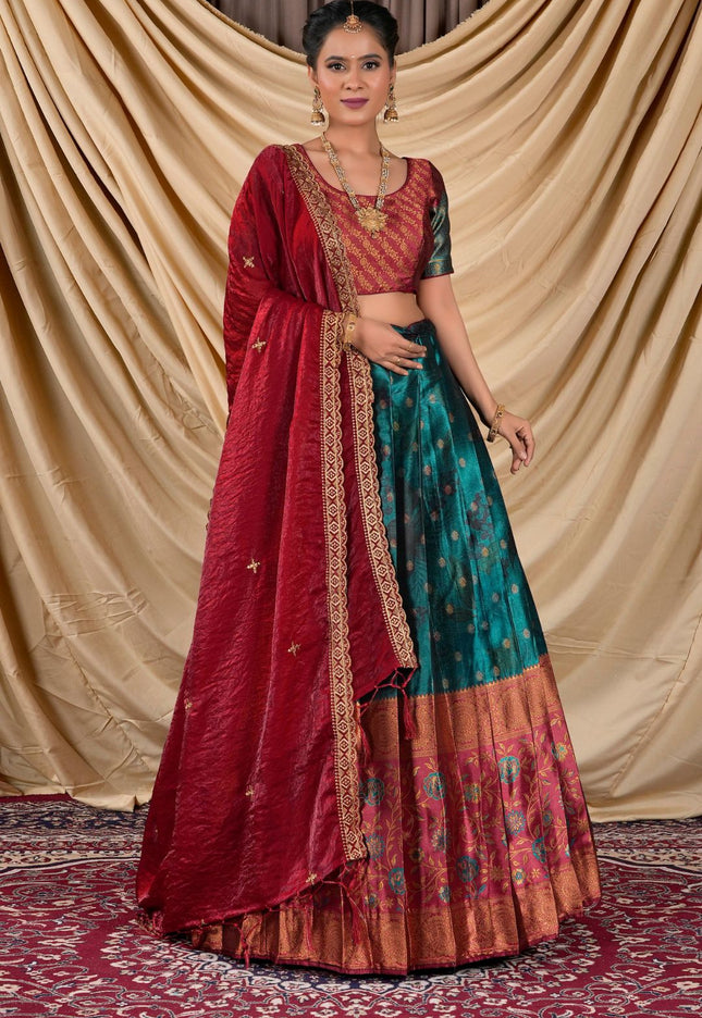 Woman wearing a traditional red and rama lehenga with a gold border