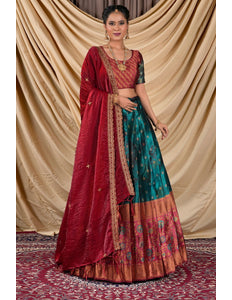 Woman wearing a traditional red and rama lehenga with a gold border