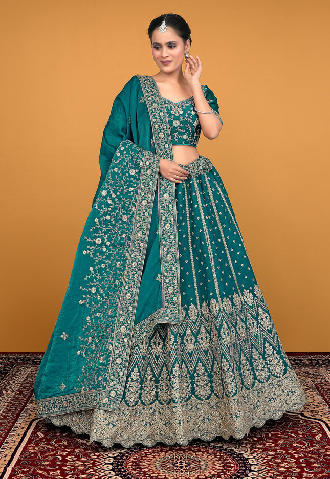 Woman in a teal embroidered traditional lehenga choli