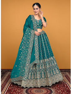 Woman in a teal embroidered traditional lehenga choli