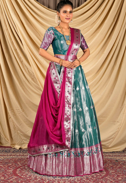 Woman wearing a traditional lehenga choli with a green and pink design