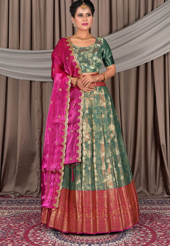 Woman wearing a traditional green lehenga with a matching blouse