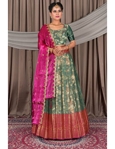 Woman wearing a traditional green lehenga with a matching blouse