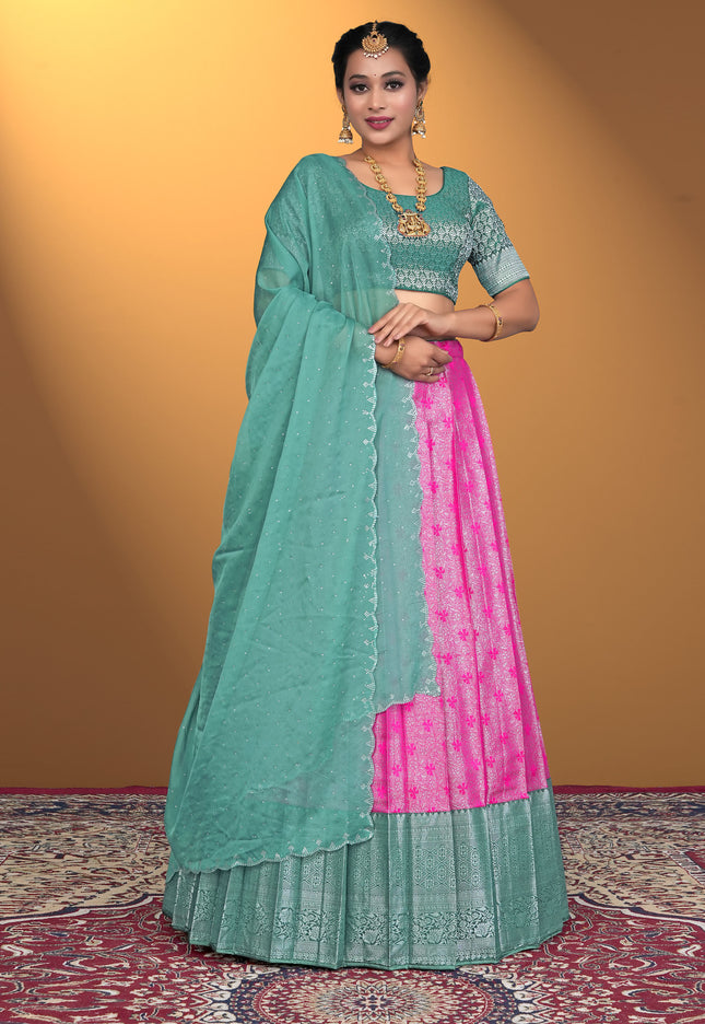Woman wearing a green and pink lehenga choli