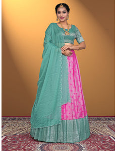 Woman wearing a green and pink lehenga choli