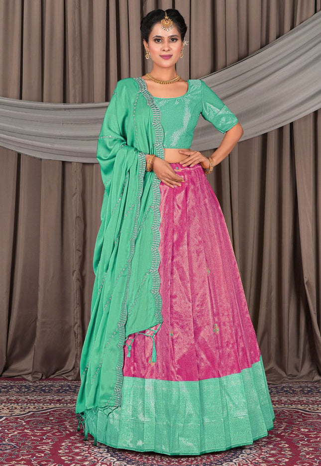 Woman wearing a green and pink traditional lehenga choli