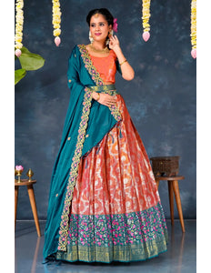 Woman wearing a pink and blue traditional lehenga choli with dupatta