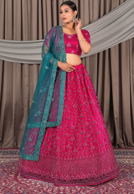 Woman wearing a pink traditional outfit with a green dupatta