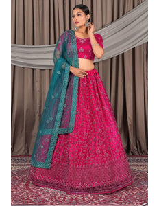 Woman wearing a pink traditional outfit with a green dupatta