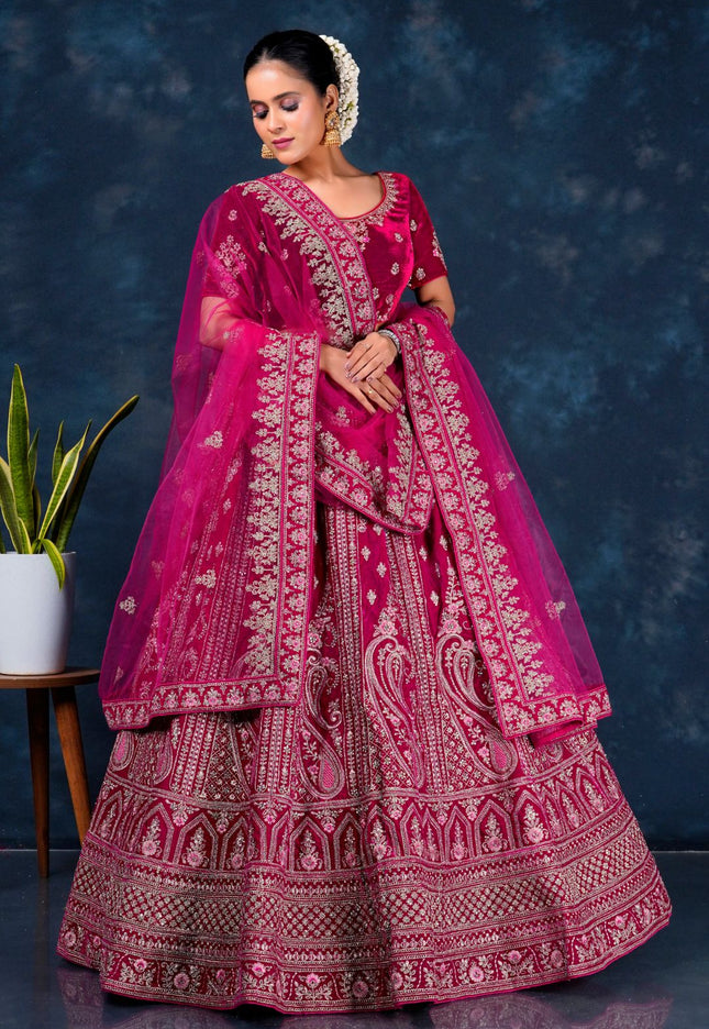 Woman in a traditional pink embroidered lehenga choli with dupatta
