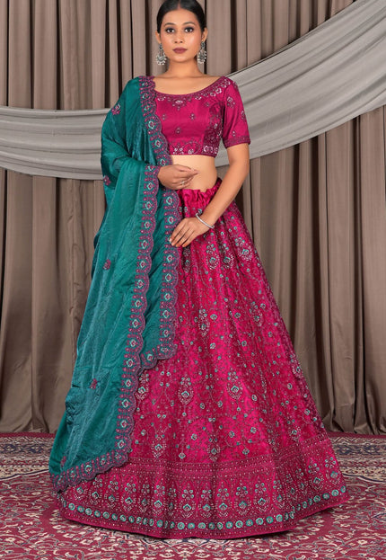 Woman wearing a pink and green traditional outfit with contrast dupatta