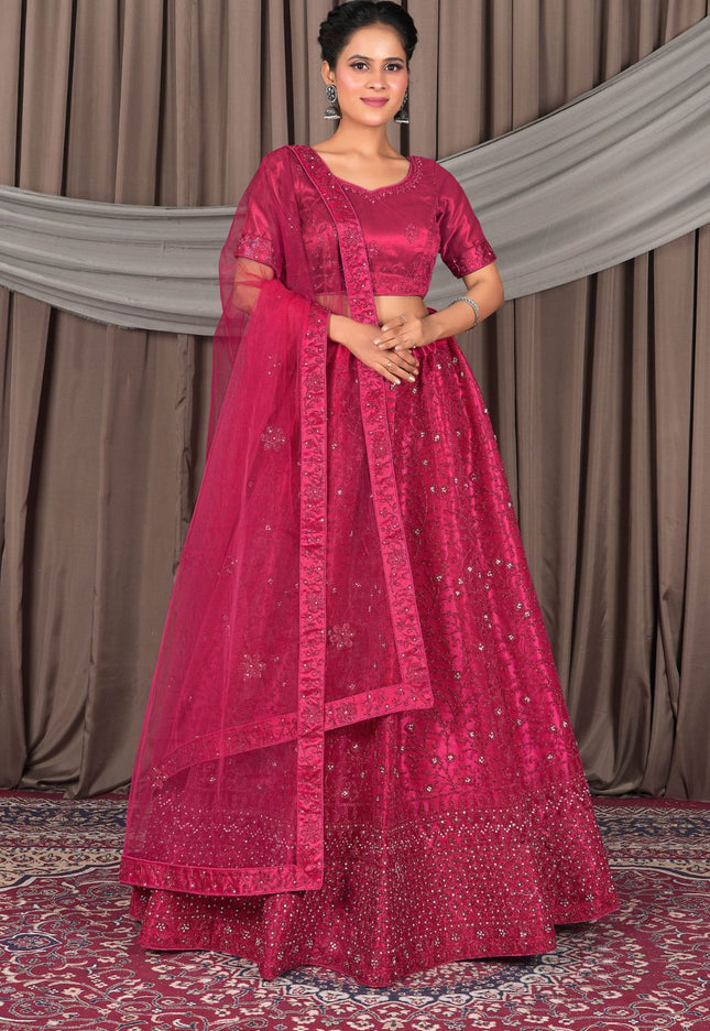 Woman wearing a traditional pink saree with a matching blouse