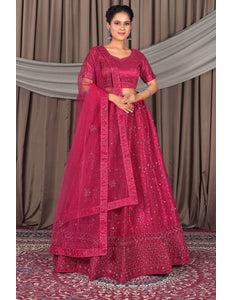 Woman wearing a traditional pink saree with a matching blouse
