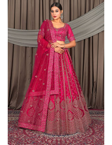 Woman wearing a pink embroidered traditional outfit
