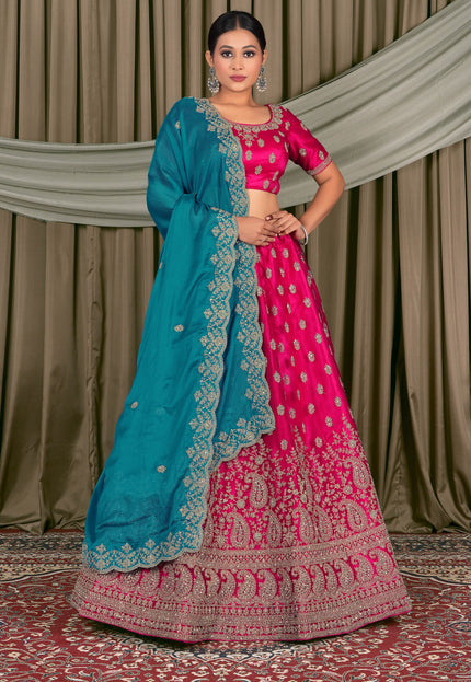 Woman wearing a traditional pink and blue lehenga choli