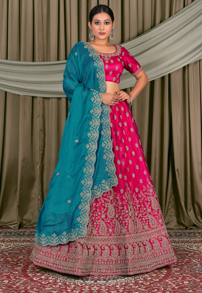 Woman wearing a traditional pink and blue lehenga choli