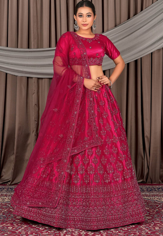 Woman wearing a traditional pink embroidered lehenga