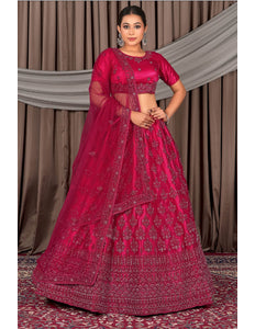 Woman wearing a traditional pink embroidered lehenga
