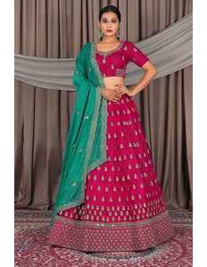 Woman wearing a pink traditional outfit with a green dupatta