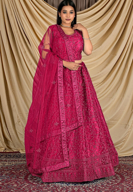 Woman wearing a pink traditional outfit with a matching dupatta