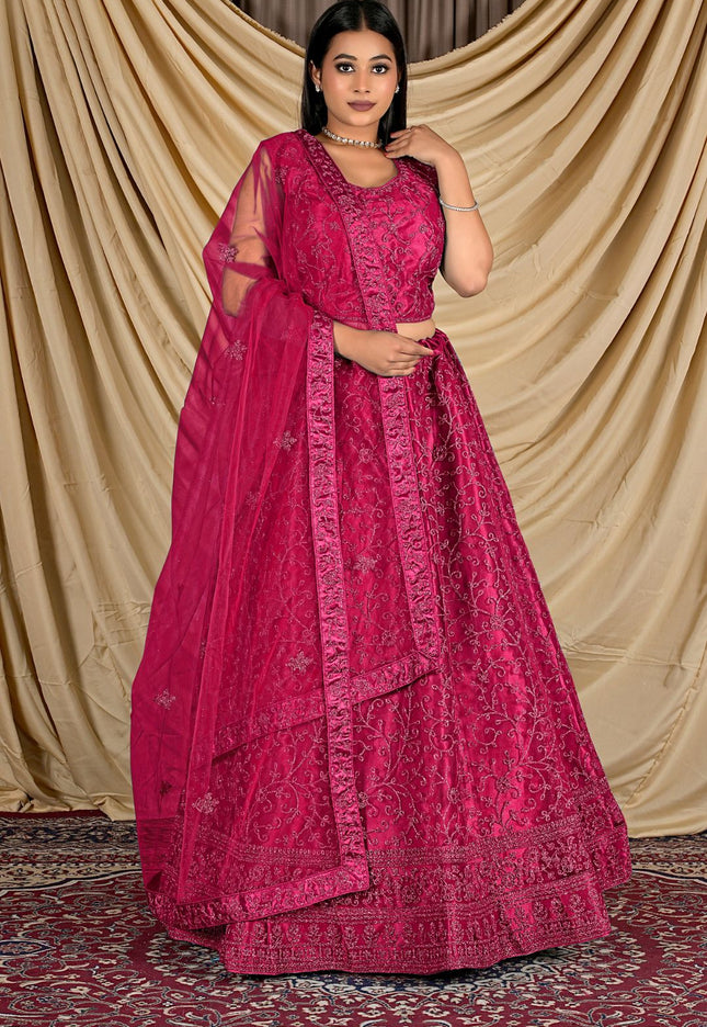 Woman wearing a pink traditional outfit with a matching dupatta