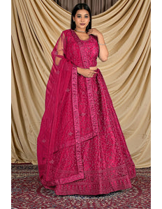 Woman wearing a pink traditional outfit with a matching dupatta