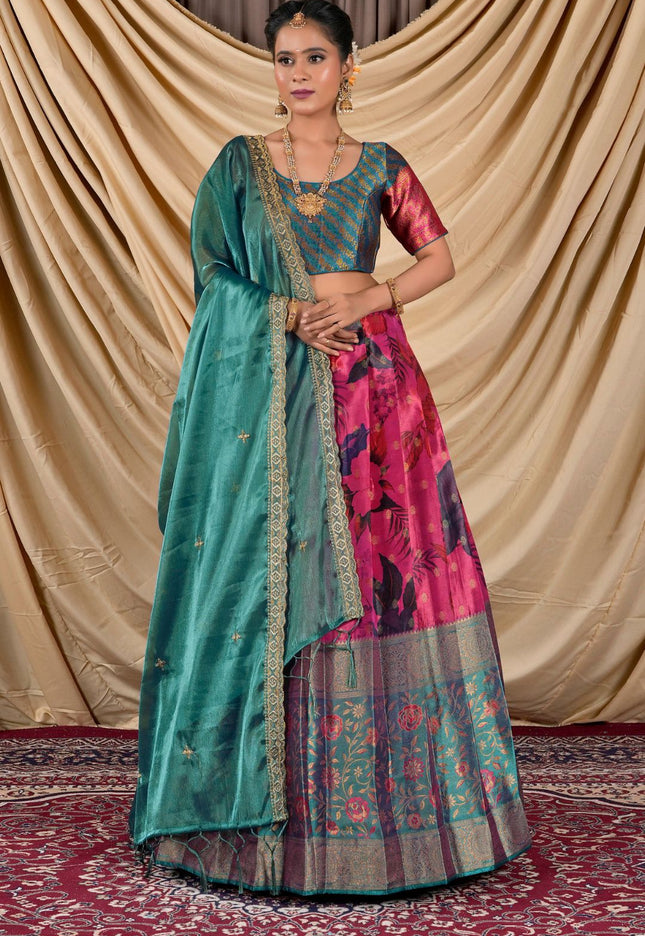 Woman wearing a traditional lehenga choli with a green and pink patterned design