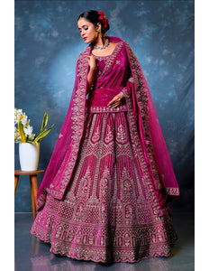 Woman in a traditional pink embroidered lehenga choli with dupatta