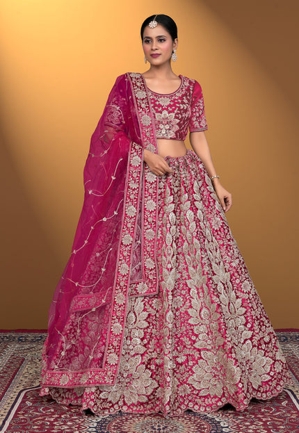 Woman wearing a pink embroidered traditional lehenga choli