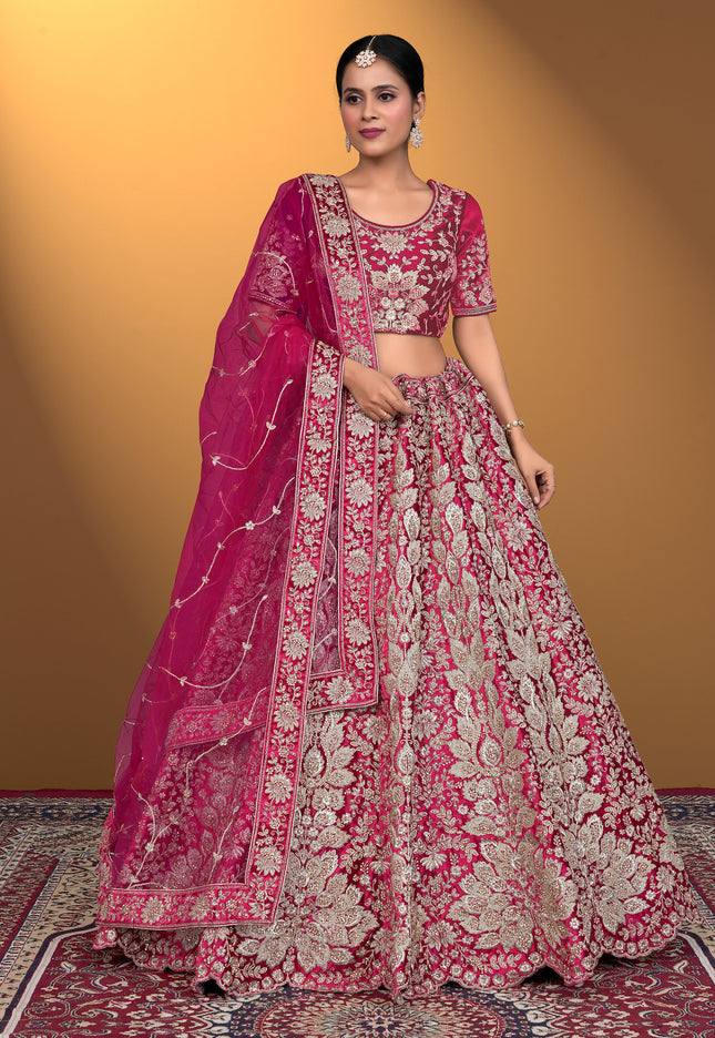 Woman wearing a pink embroidered traditional lehenga choli