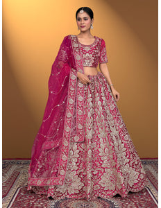 Woman wearing a pink embroidered traditional lehenga choli