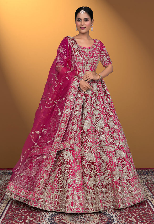 Woman wearing a traditional pink embroidered lehenga choli