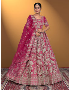 Woman wearing a traditional pink embroidered lehenga choli