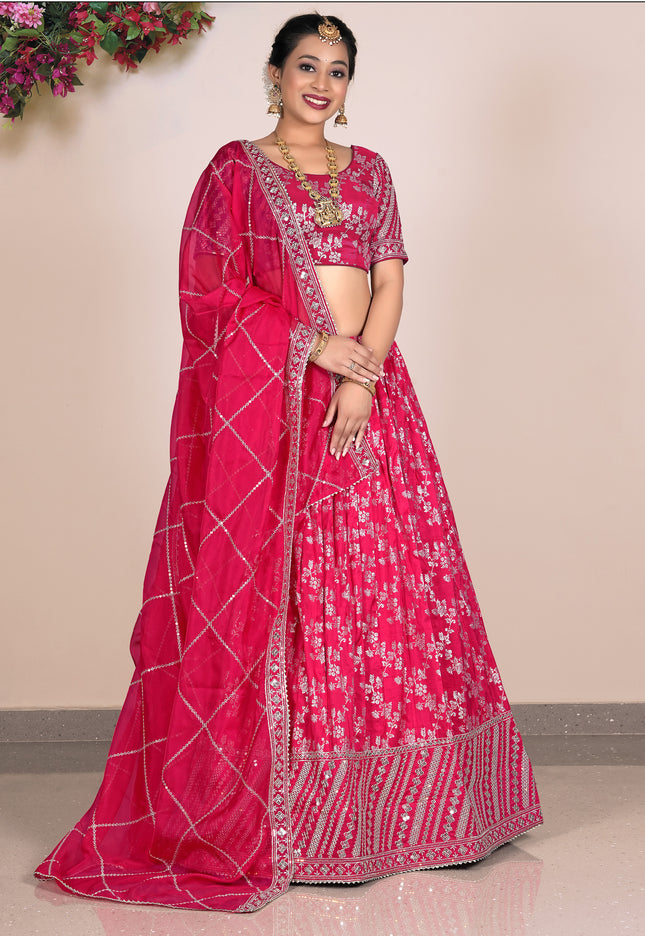 Woman wearing a pink lehenga with a matching blouse