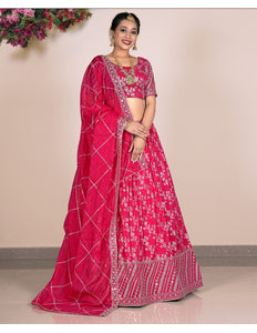 Woman wearing a pink lehenga with a matching blouse